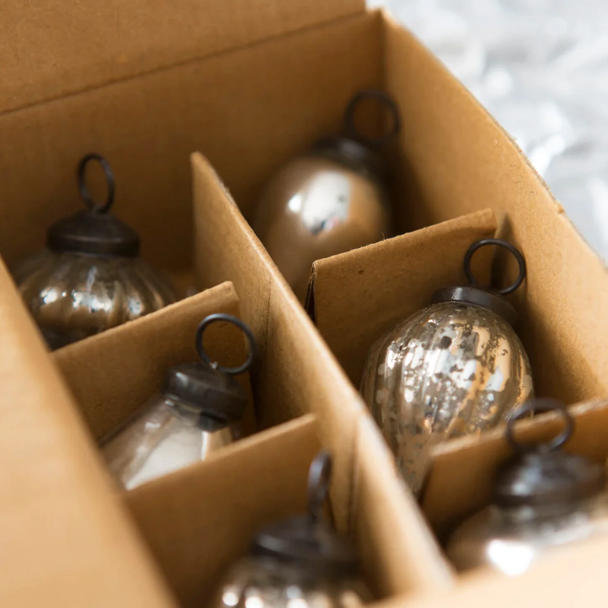 Box of mercury glass Christmas ornaments