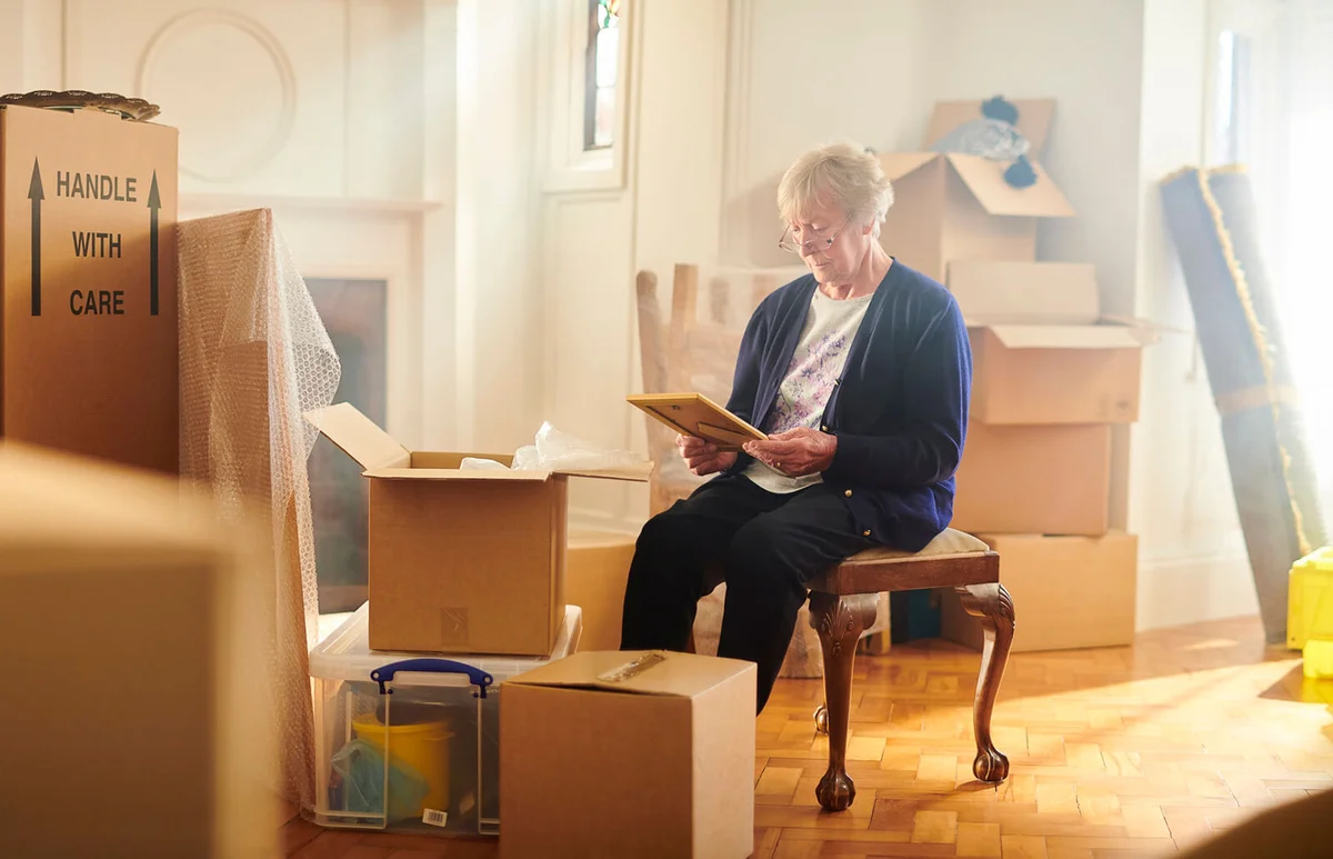 woman looks through some memories just before the house move begins