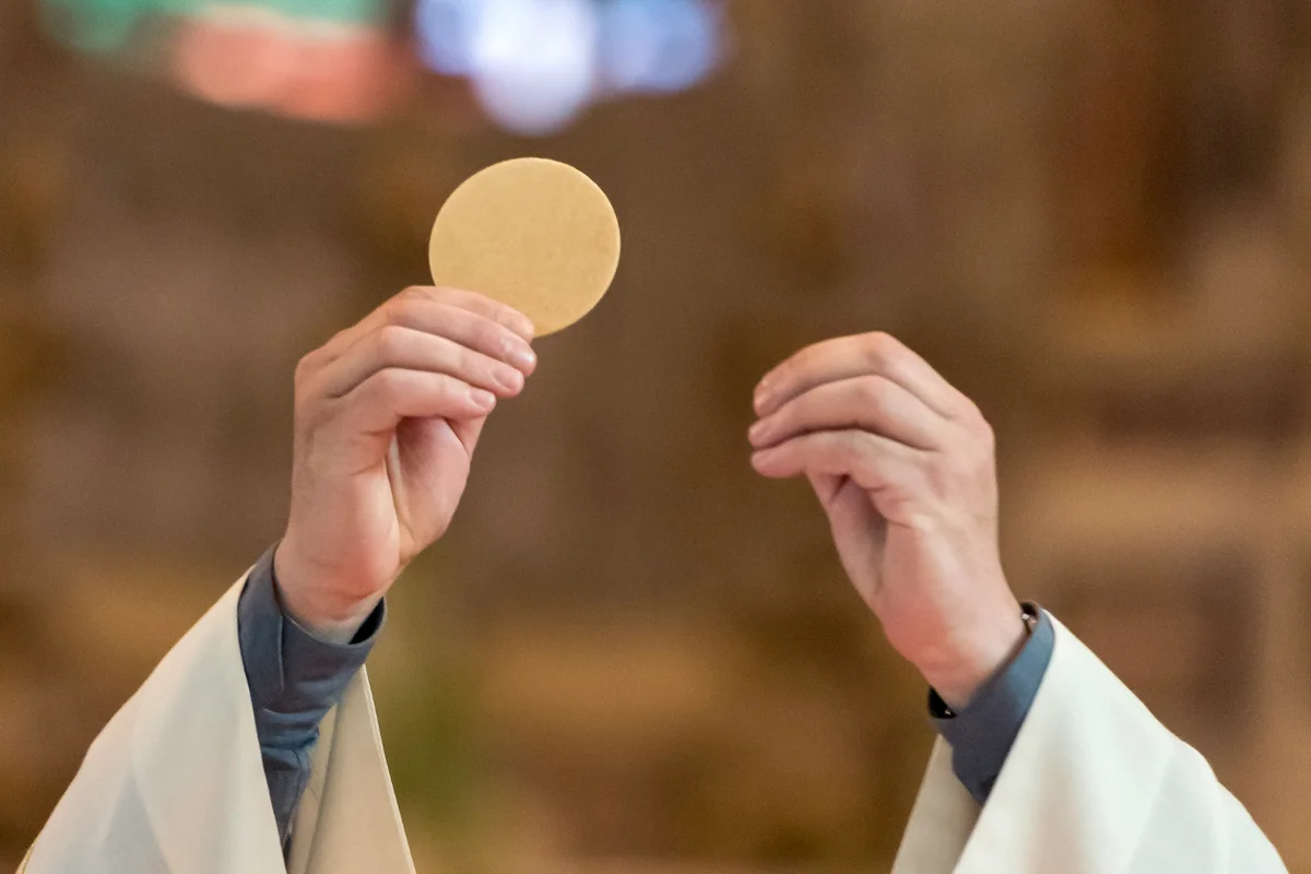 Priest giving out communion