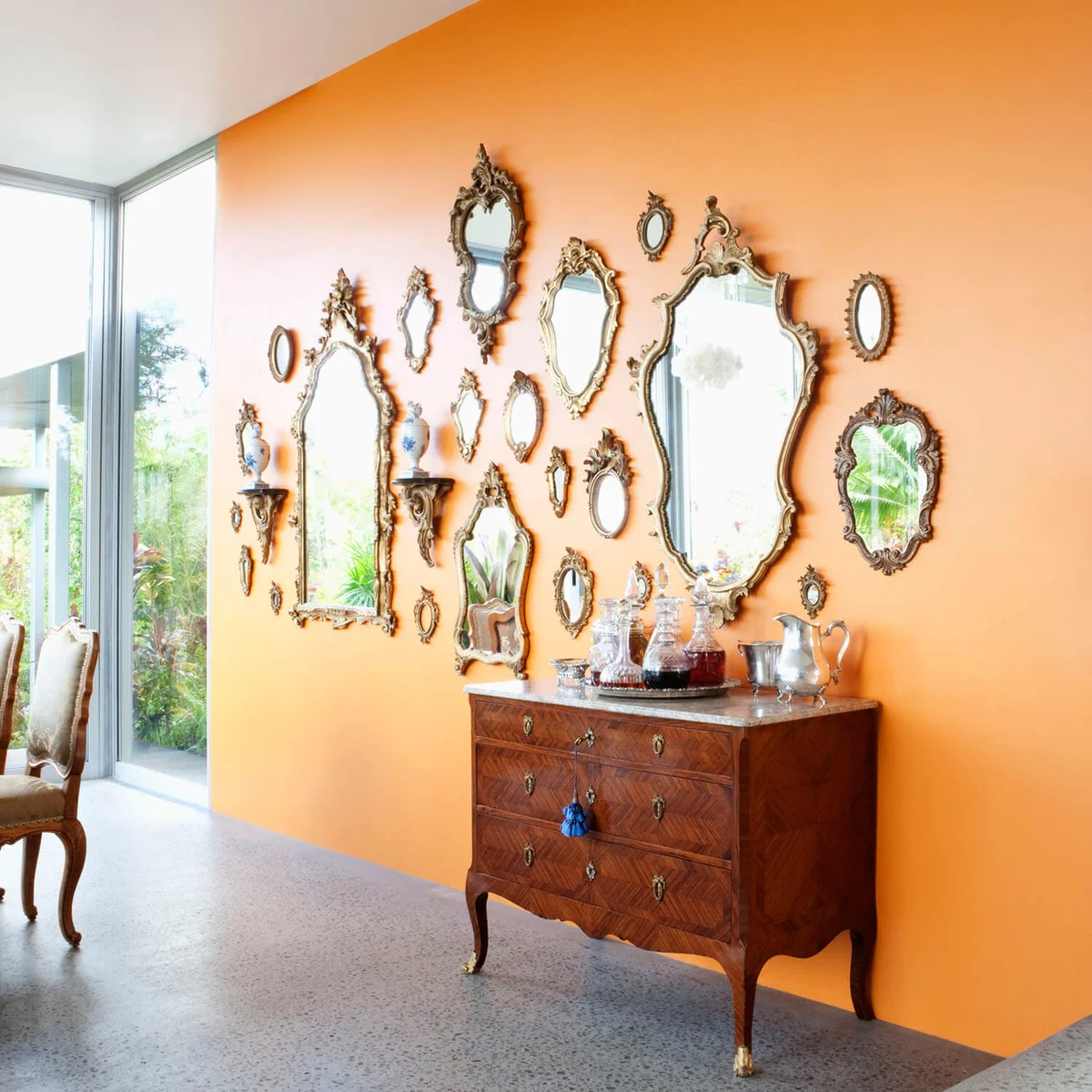 Mirrors on orange wall