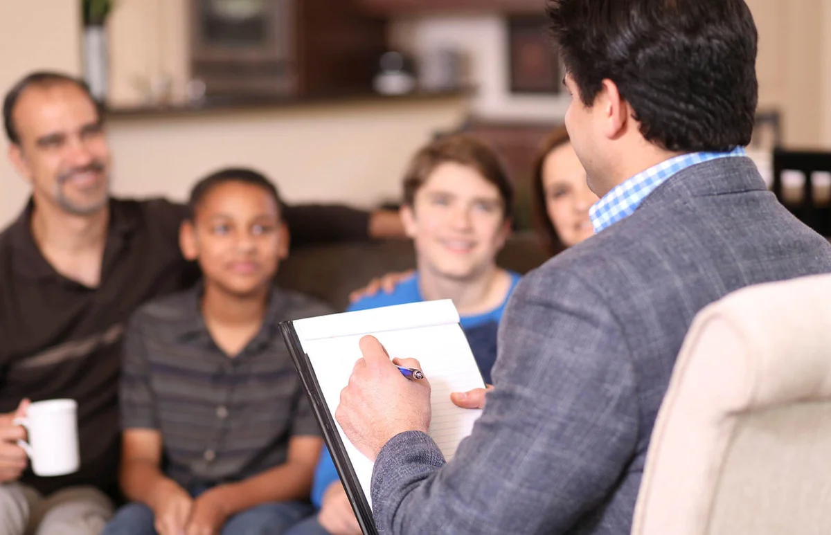 Family counseling session at home with therapist