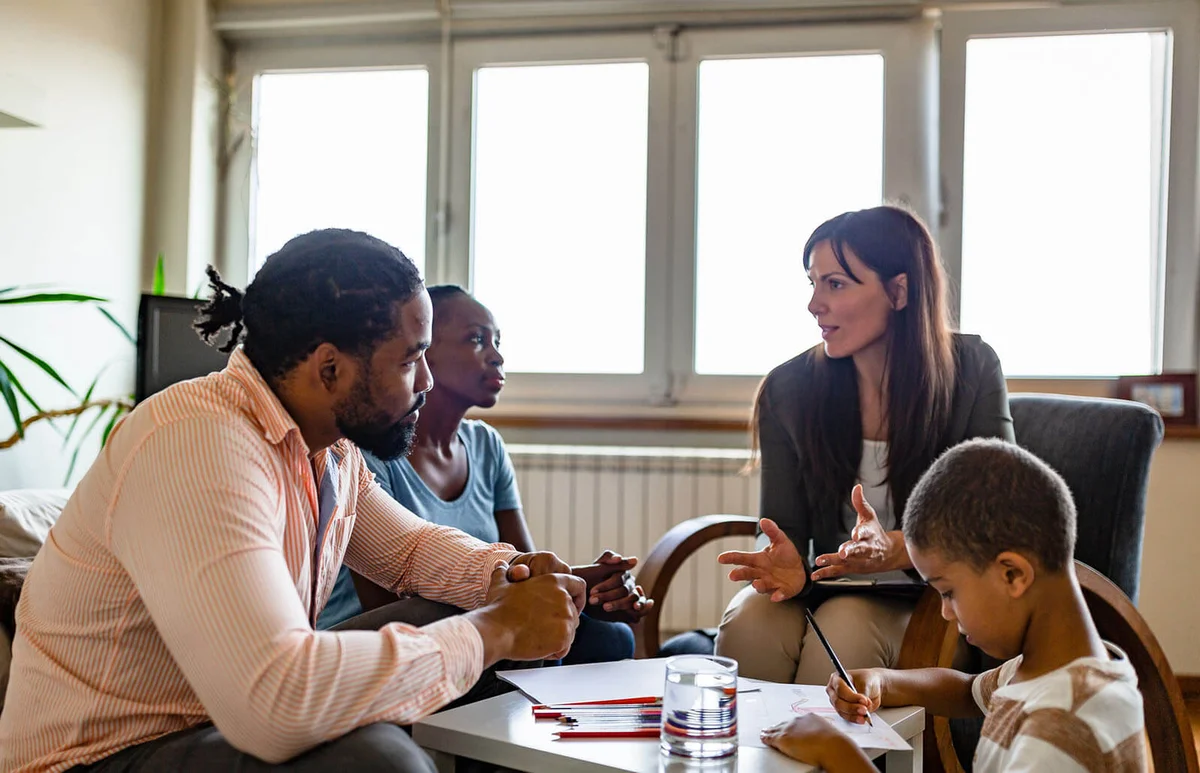 Family with one child on a session with a counselor