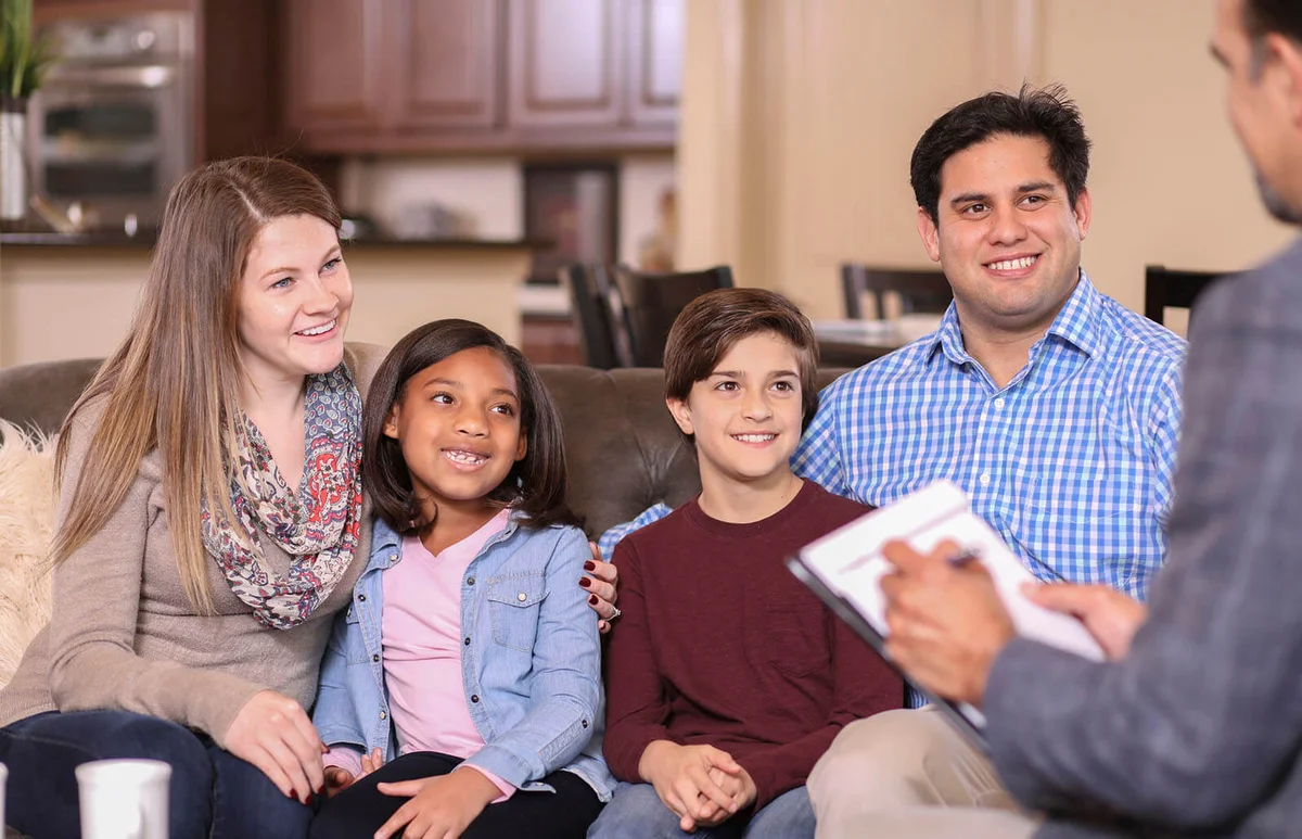 Family counseling session at home with therapist
