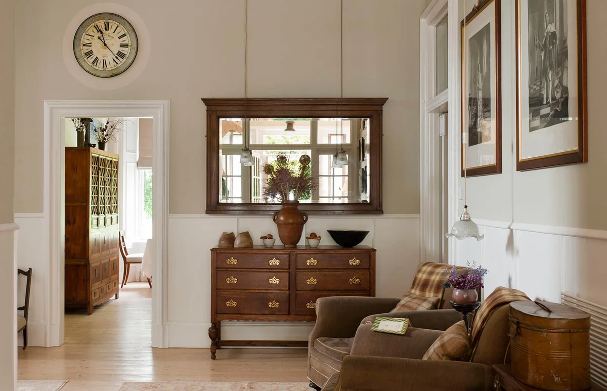 Antique wooden drawers and mirror in hallway