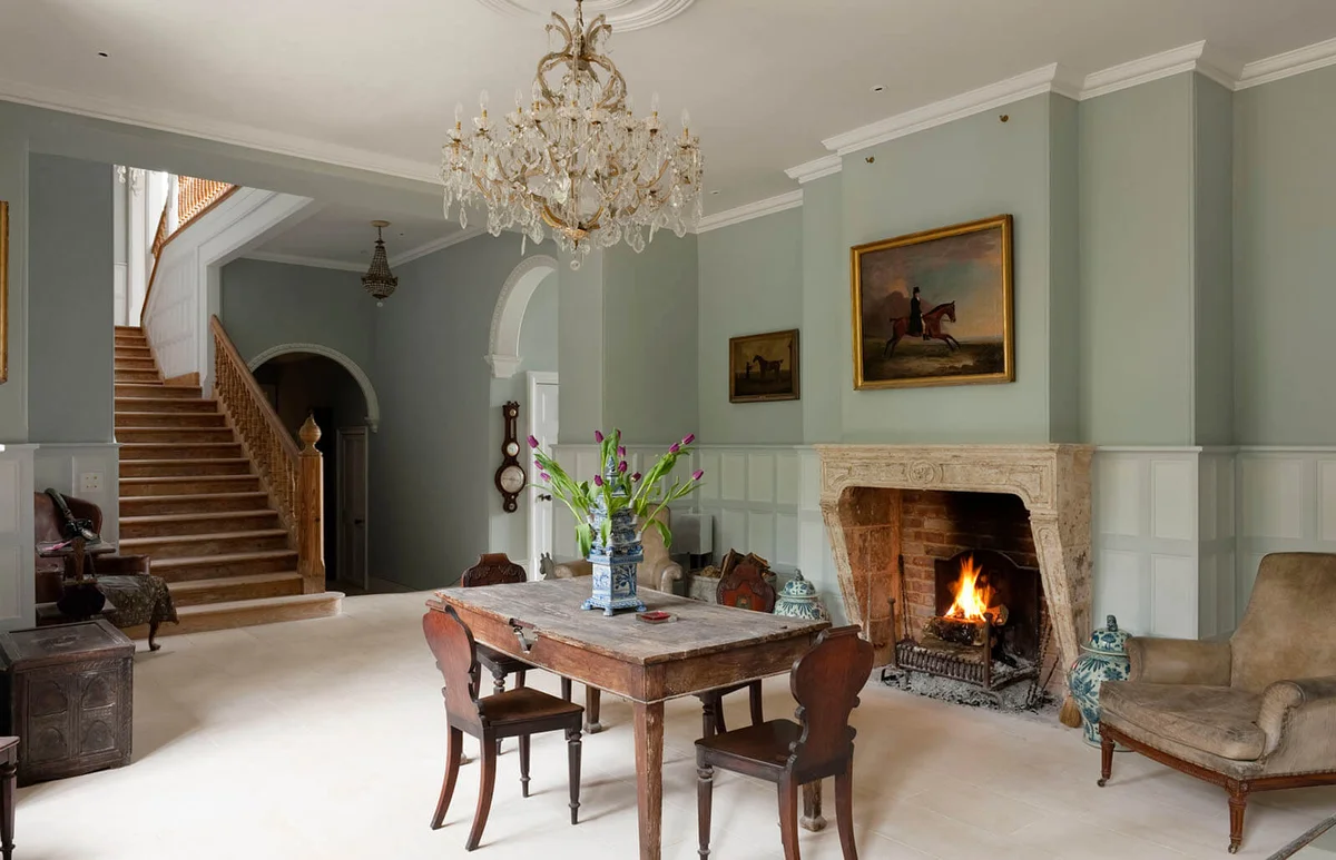White painted panelled reception room of Gloucestershire country estate
