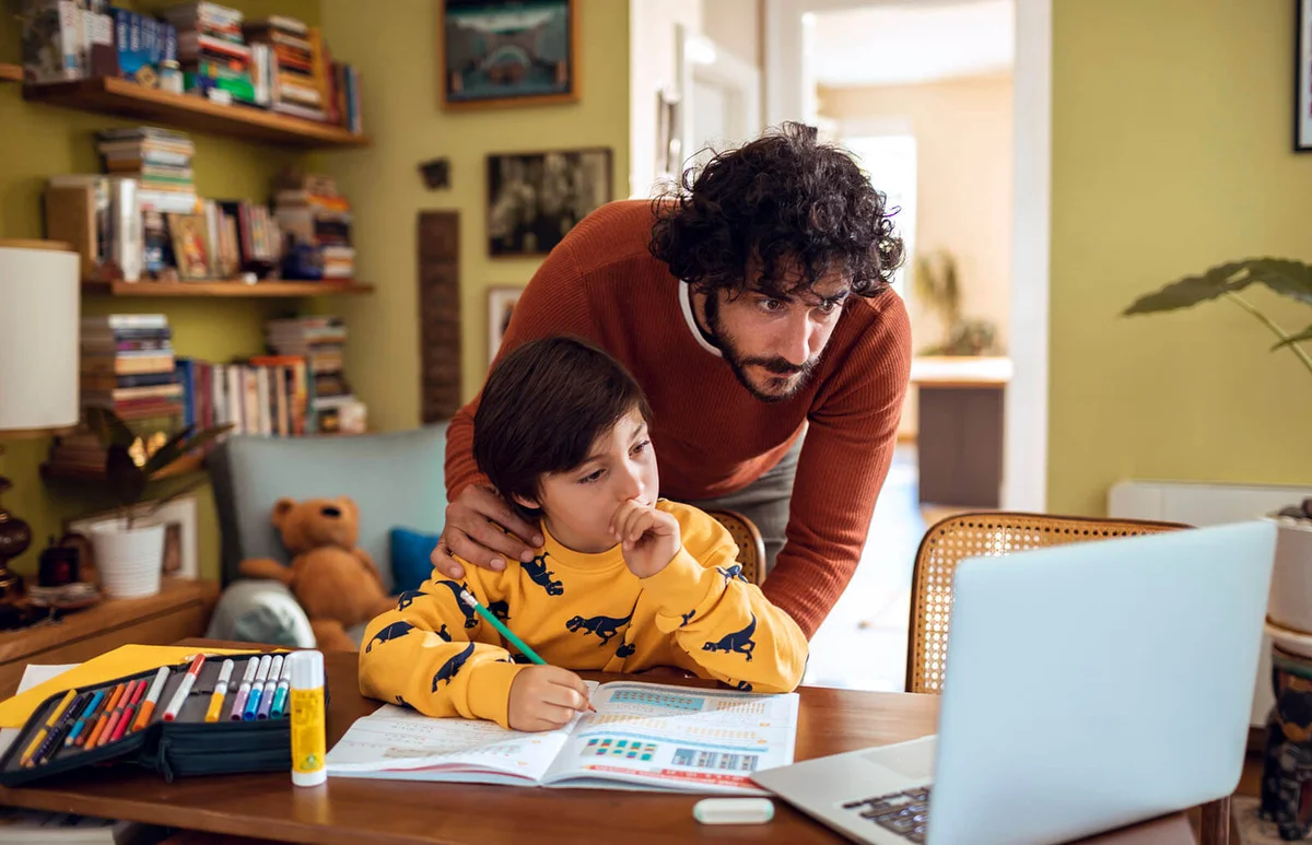 Father helping his son with schoolwork
