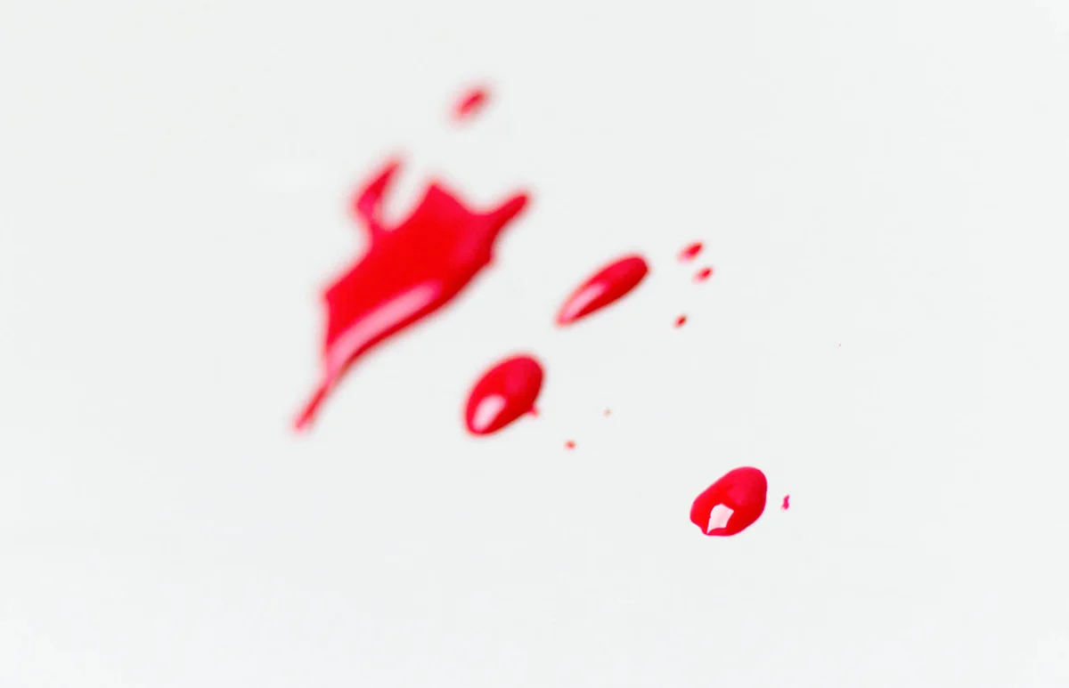 Red nail polish spilled on wall