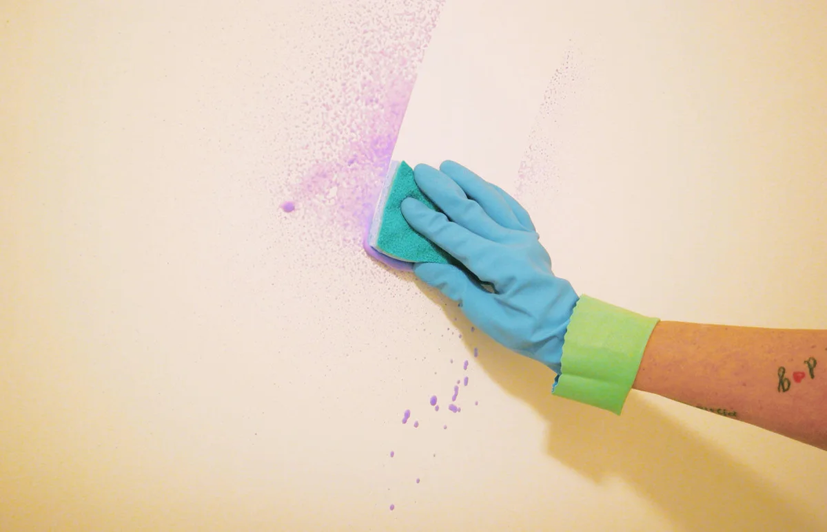 Woman cleaning wall
