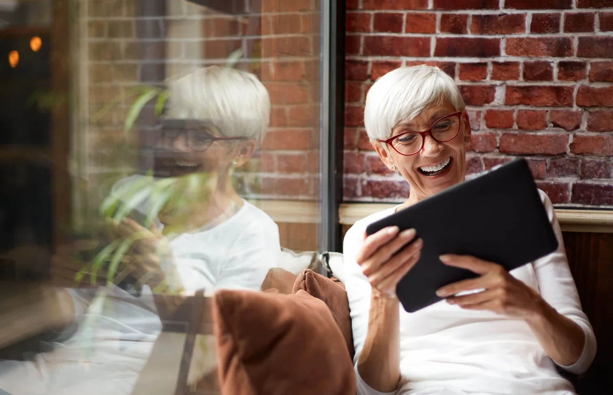 Elderly woman using a digital tablet