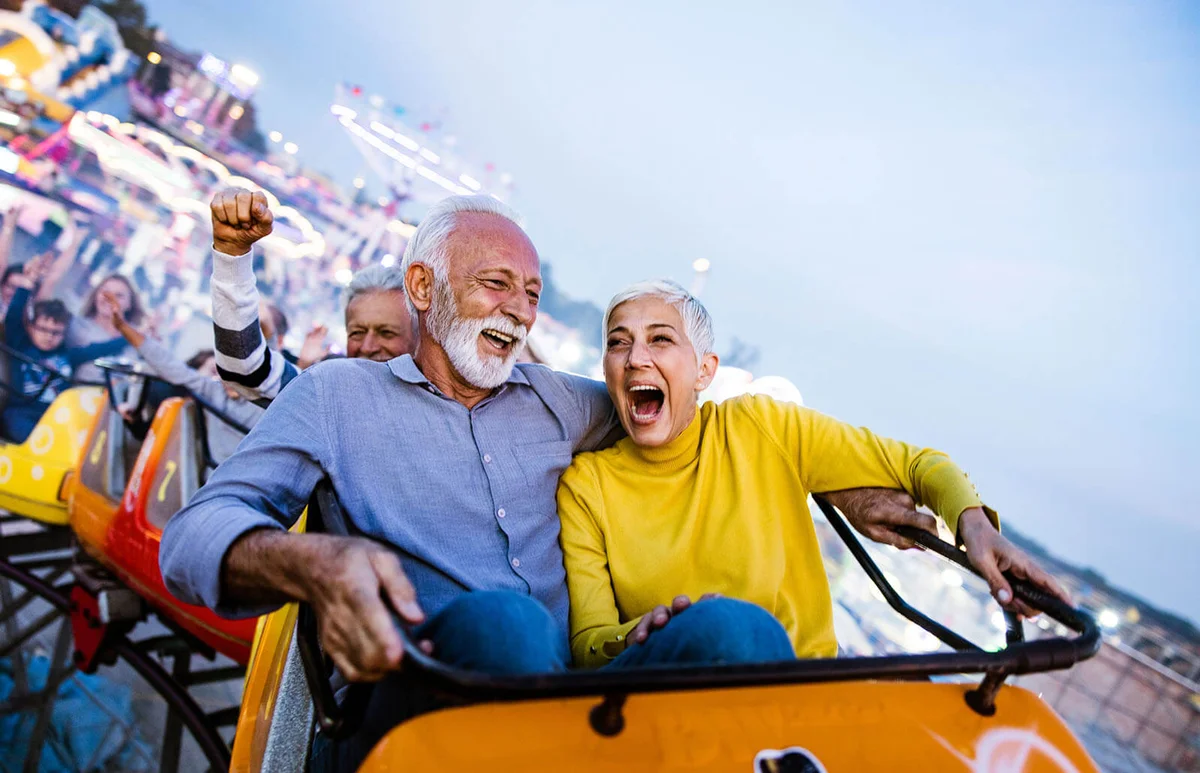 Carefree seniors having fun on rollercoaster