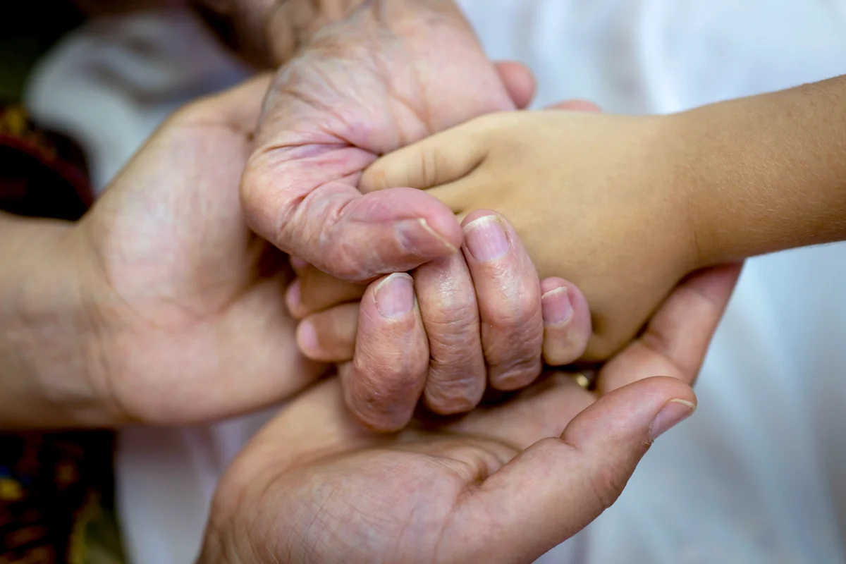 Three generations holding hands