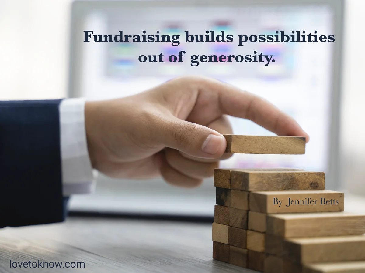 Hand arranging wood block stacking as step stair and fundraising quote