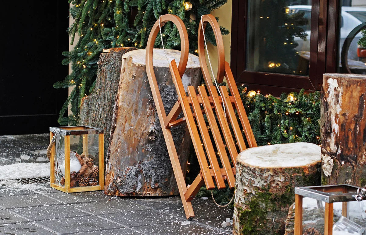Wooden sled with stumps and glass candlesticks
