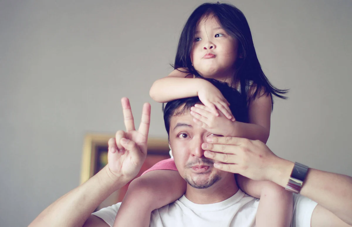 Little girl getting shoulder back ride