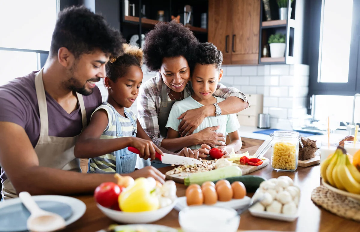 Happy family in the kitchen having fun and cooking together