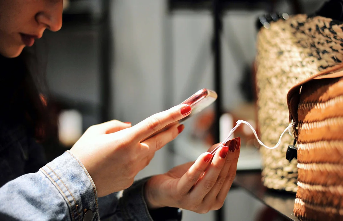 Woman scanning a barcode at a shop for a bag