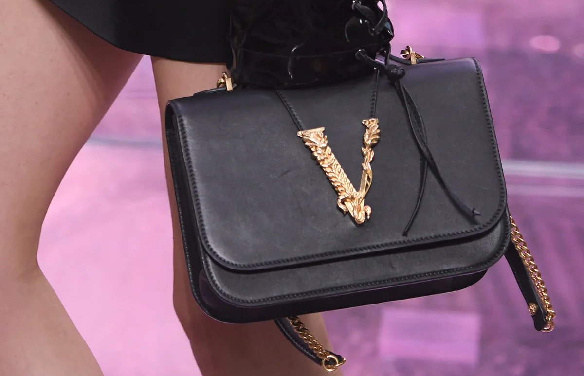 A model, bag details, walks the runway at the Versace fashion show | Getty Editorial Use