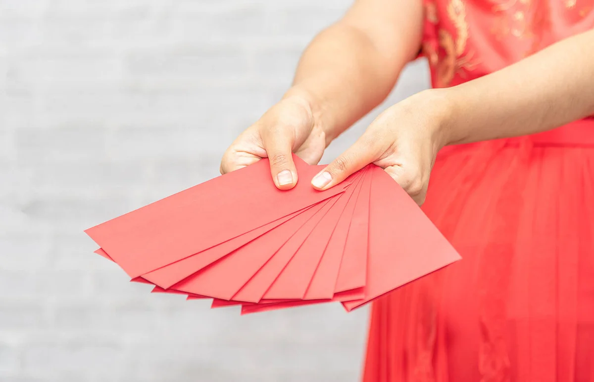 Woman holding red envelopes
