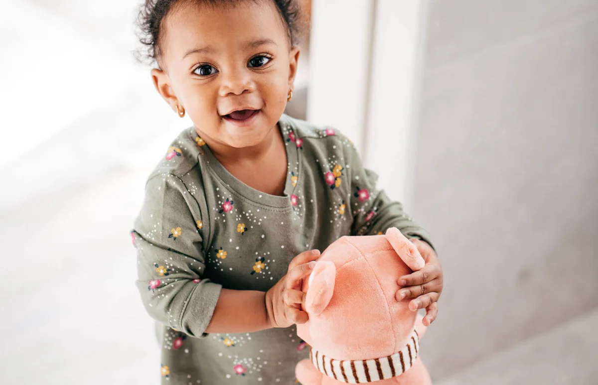 Smiling toddler with toy