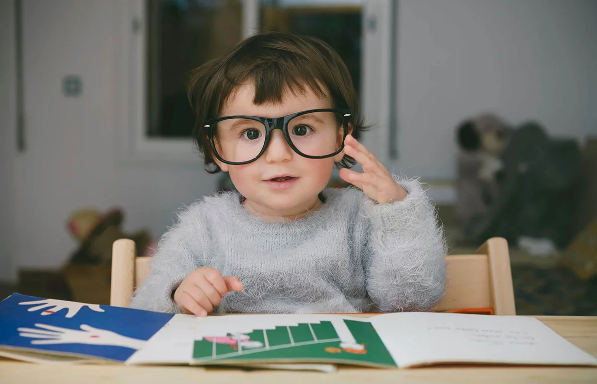 Portrait of relaxed baby girl wearing oversized glasses