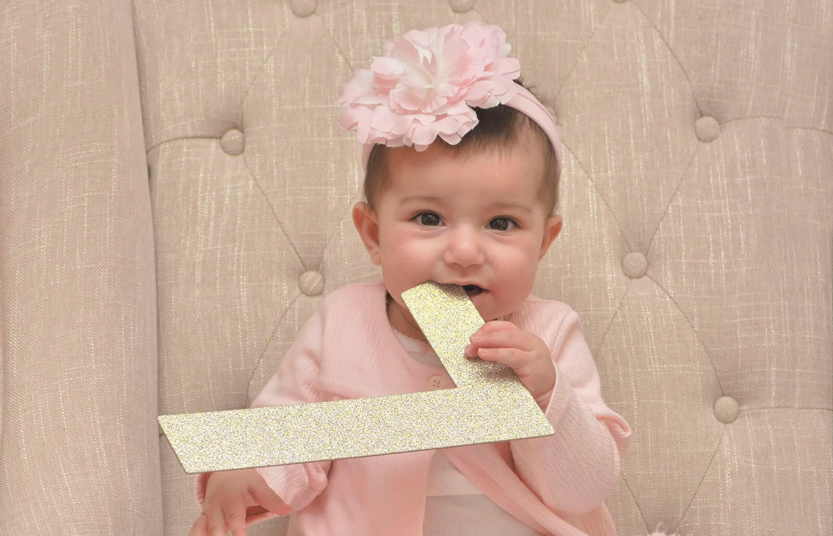 Cute Baby Girl Biting Letter L