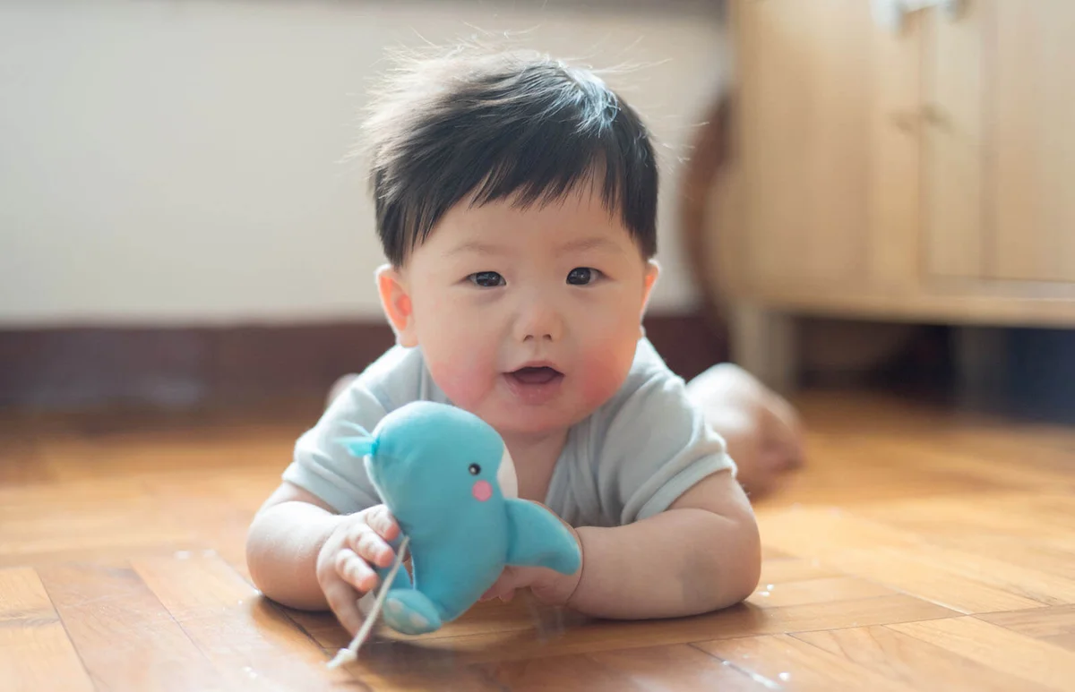 Baby boy playing toy whale