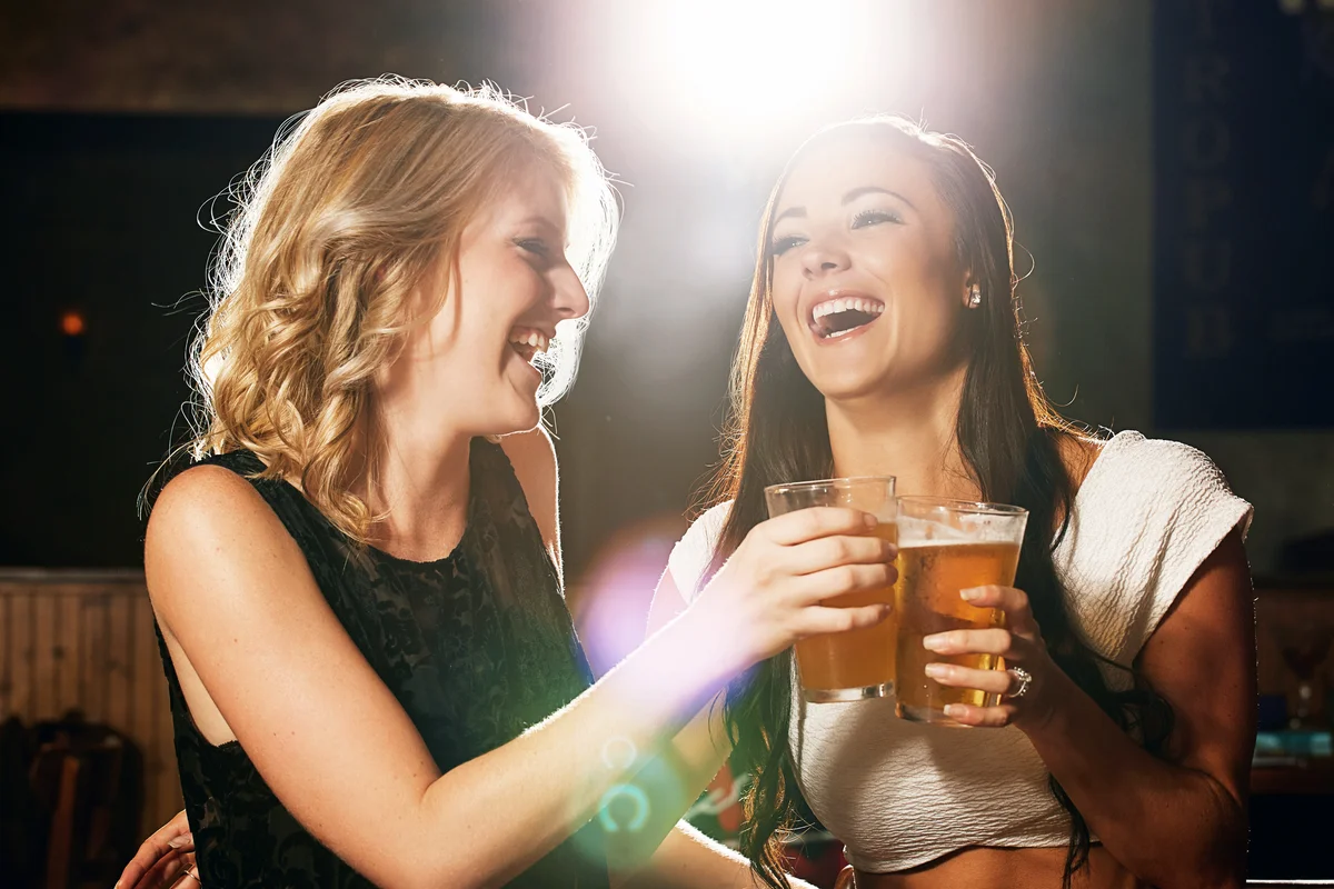 Women enjoying her drinks together in a nightclub
