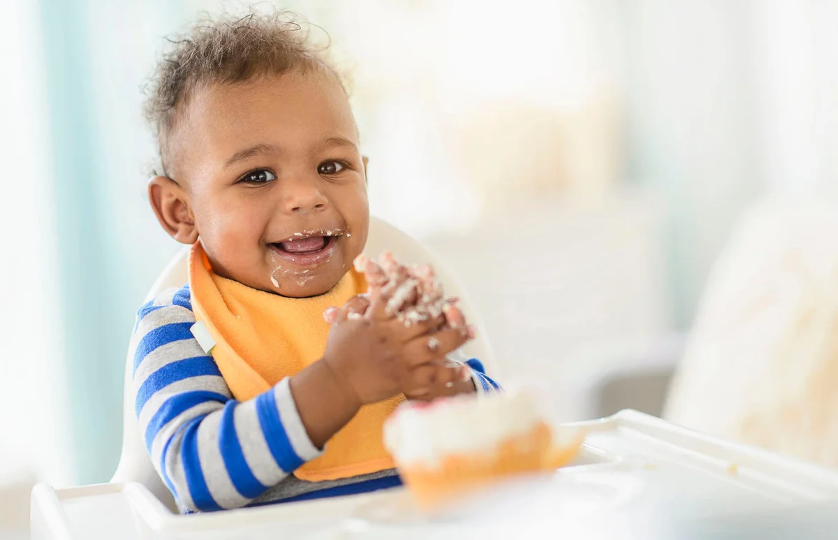 baby boy eating in high chair