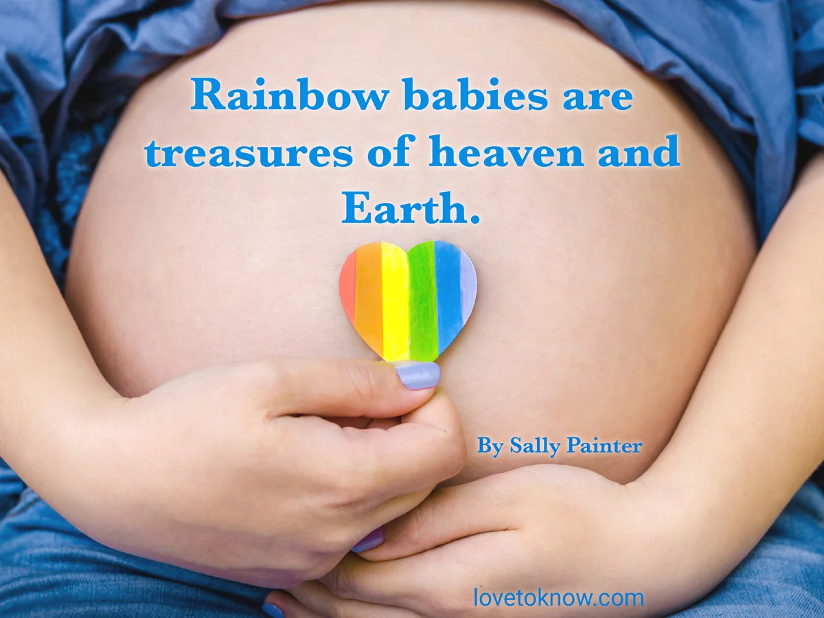Pregnant woman shows a rainbow heart on her belly and rainbow baby quote