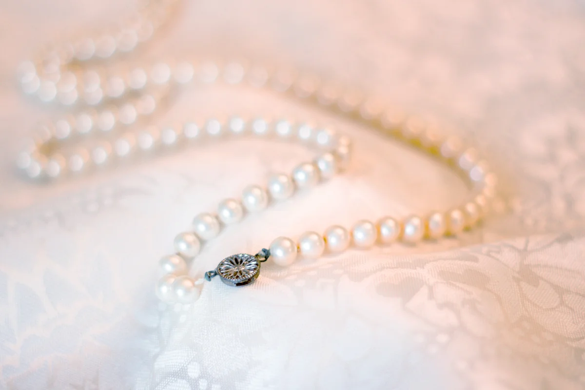 Vintage pearl necklace on floral satin fabric