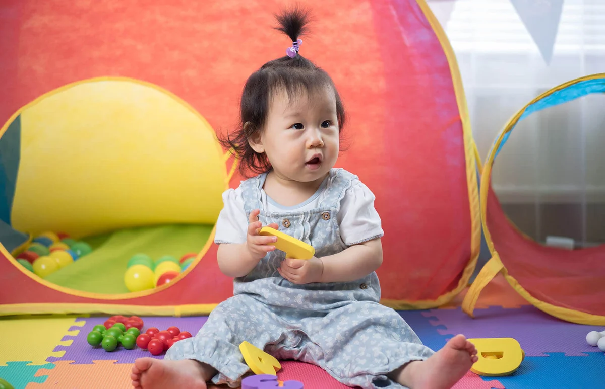 baby girl playing alphabet blocks