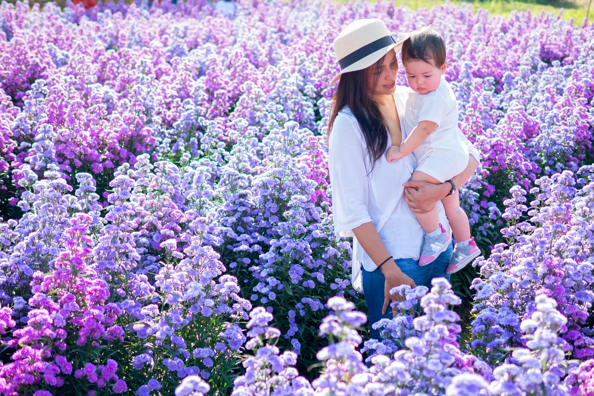 Mother and baby are in the blooming garden together