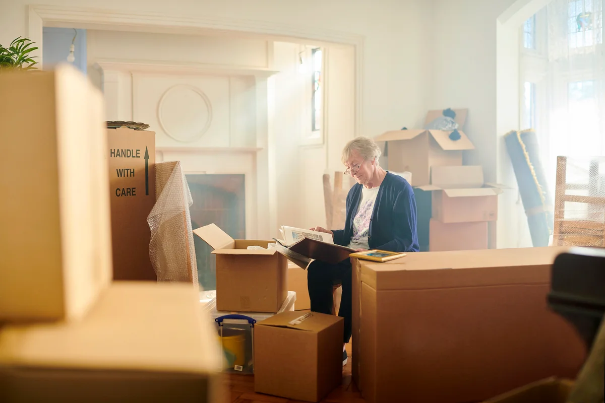 Senior woman looks through some memories just before the house move begins