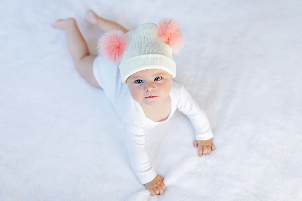Baby girl with warm white and pink hat