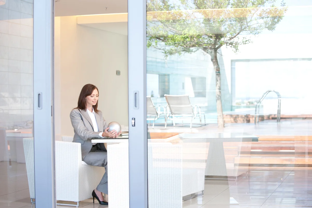 Businesswoman sitting in hotel lobby holding a crystal ball