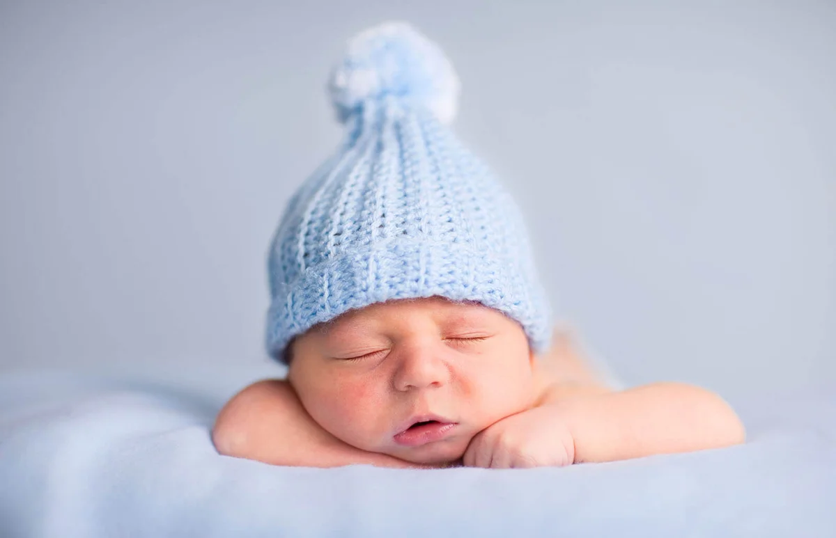 Newborn Baby Boy Sleeping Peacefully Wearing Knit Hat