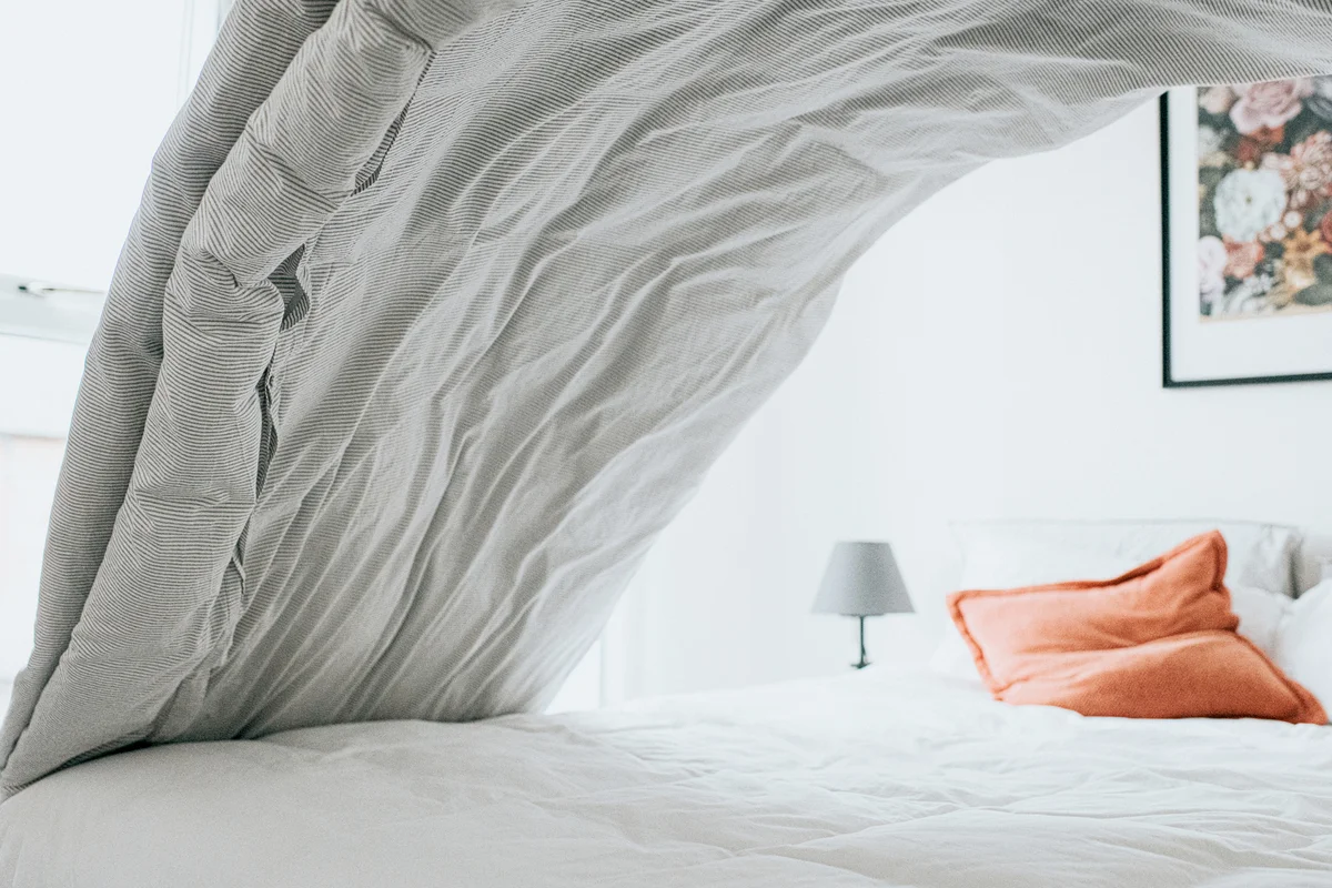 Making the bed with clean comforters