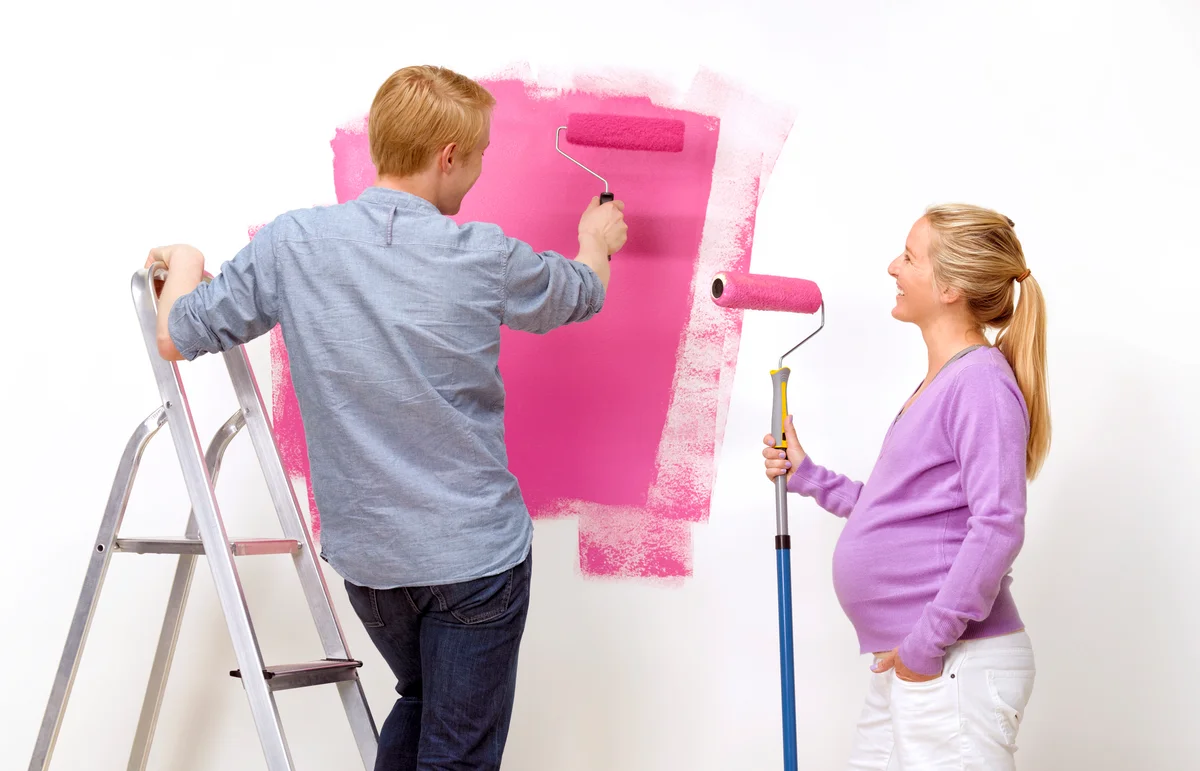 Couple painting nursery room
