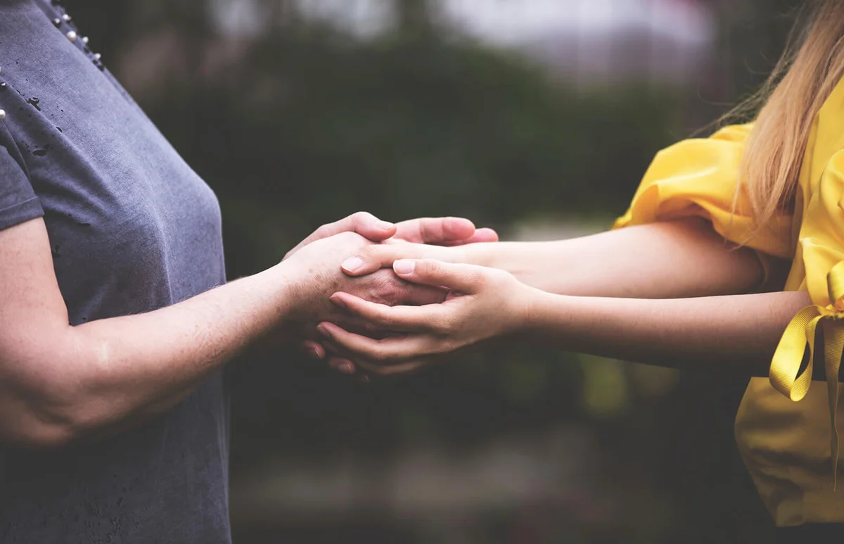 Old and Young helping hands connected