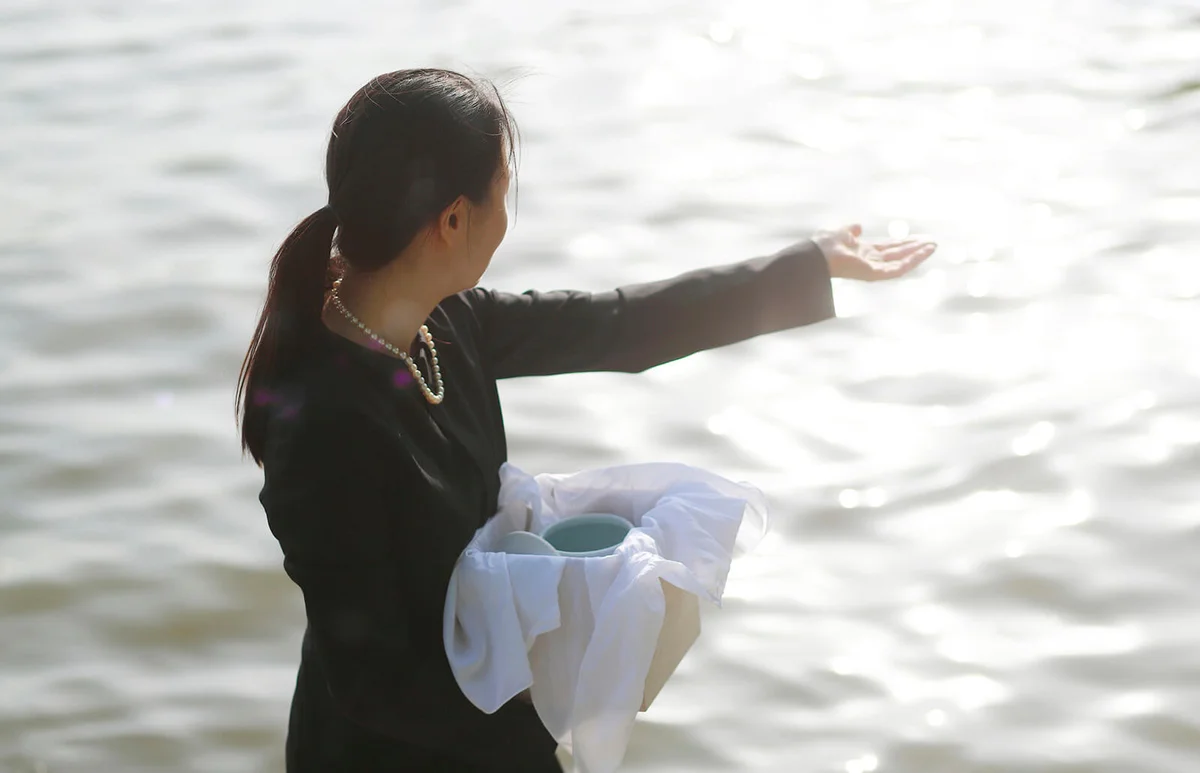 Woman with urn spreading ashes