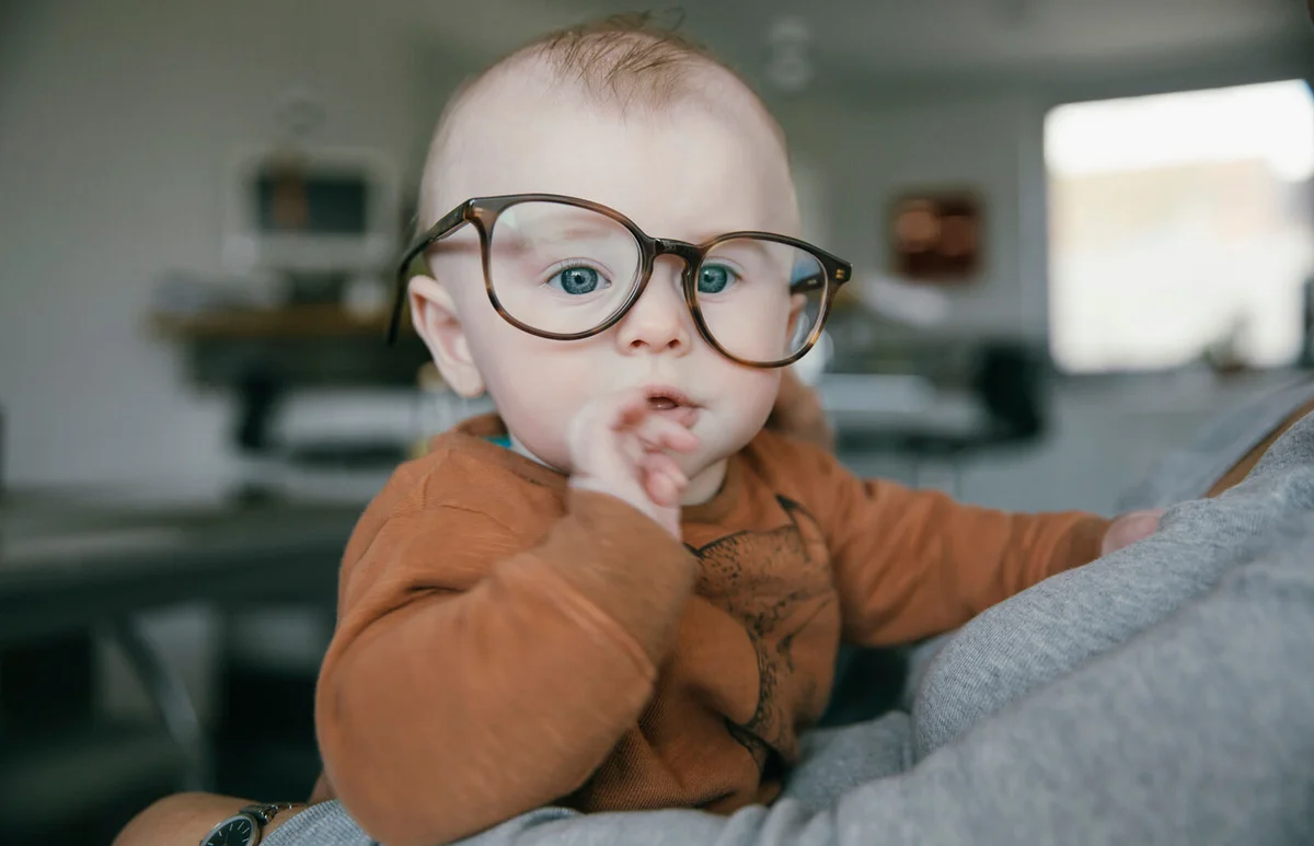Baby boy wearing oversized glasses