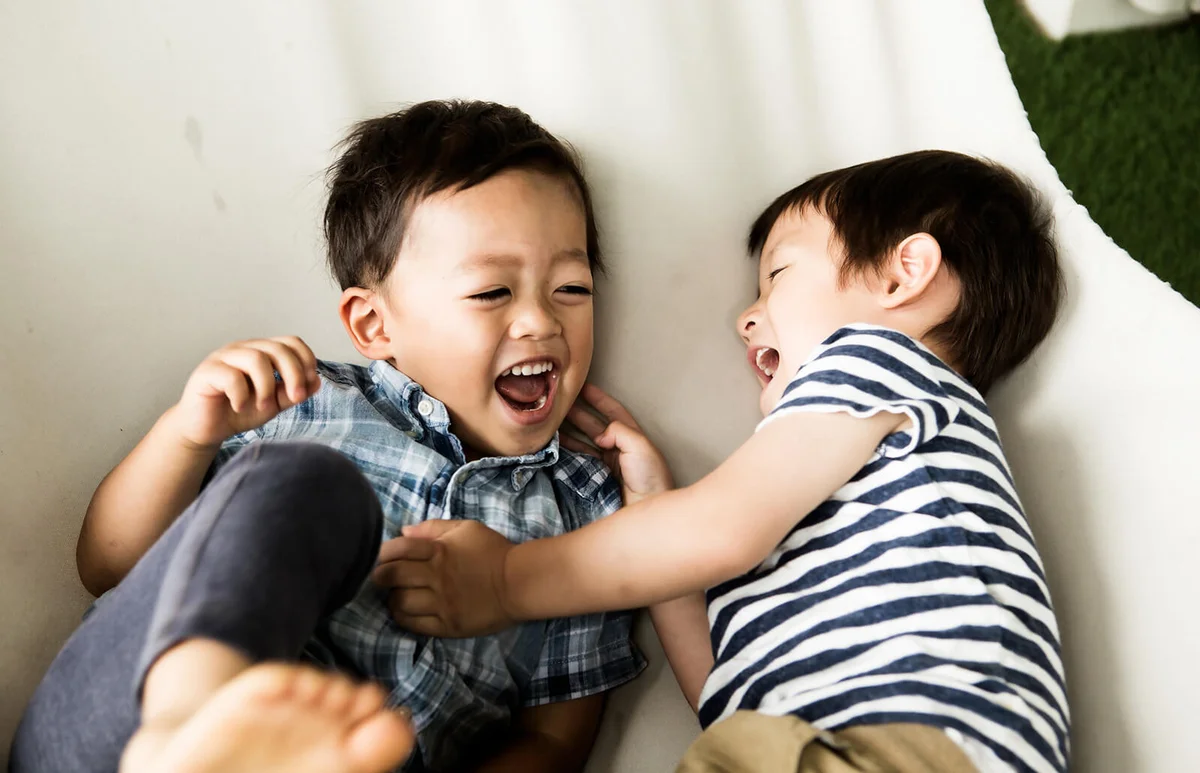 Boys playing in a hammock