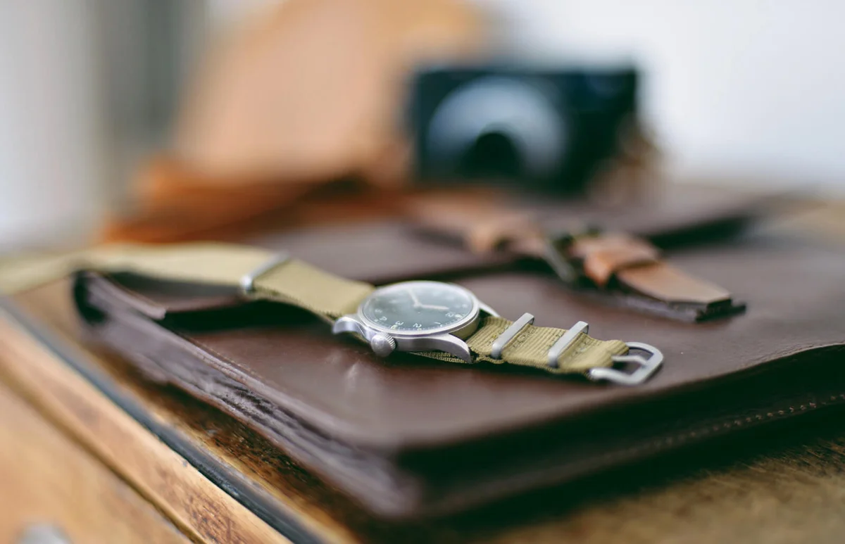 Military wristwatch on wooden cabinet