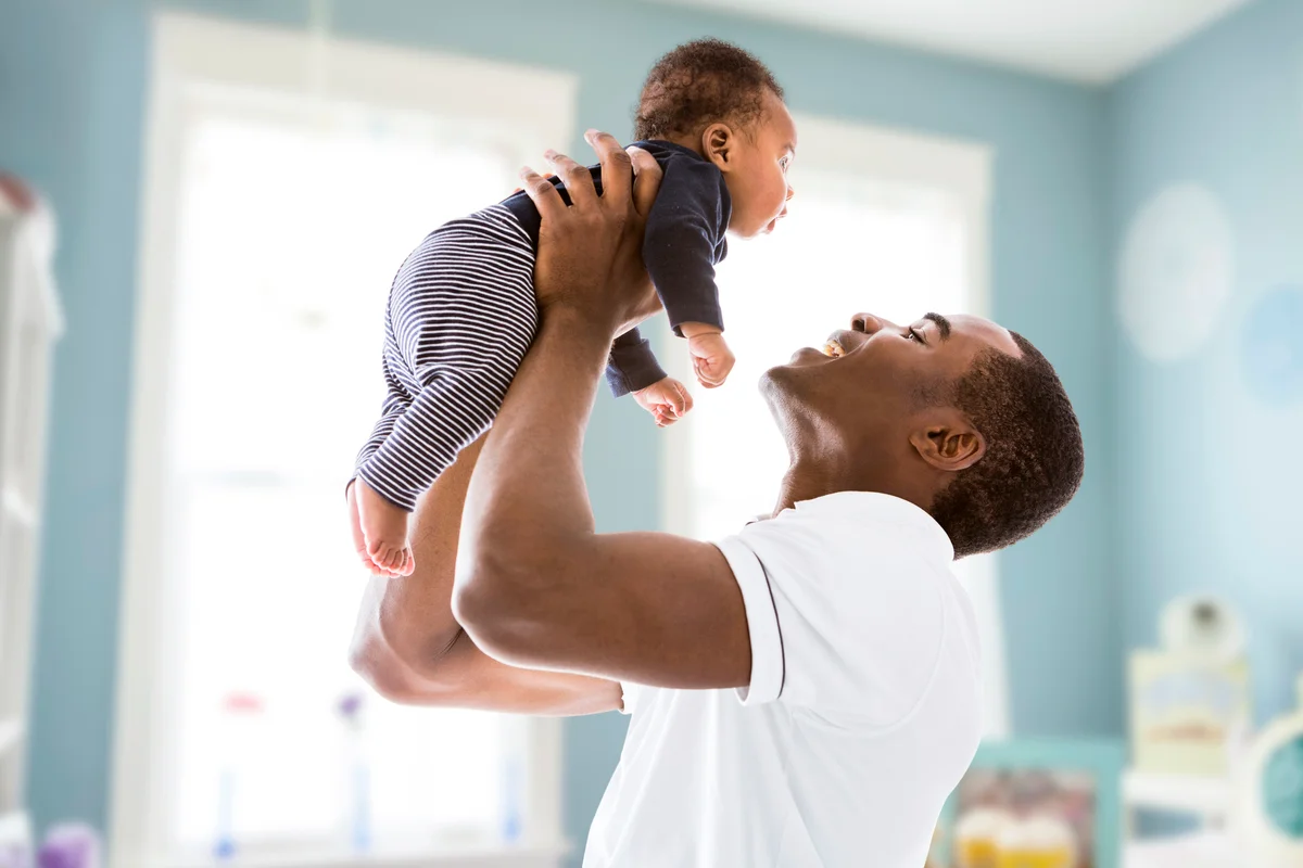 Father lifting baby son
