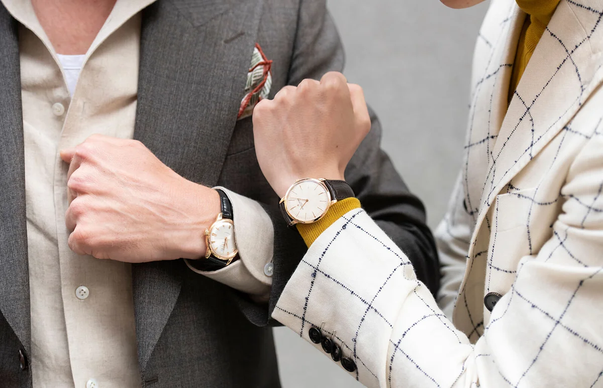 Creative consultant and digital influencer Mathias Le Fèvre wears a Daks blazer and Vacheron Constantin watch with Photographer Alistair Guy wearing an Edward Sexton suit and Longines watch during London Fashion Week Men's June 2019 on June 08, 2019 in London, England. | Getty Editorial Use