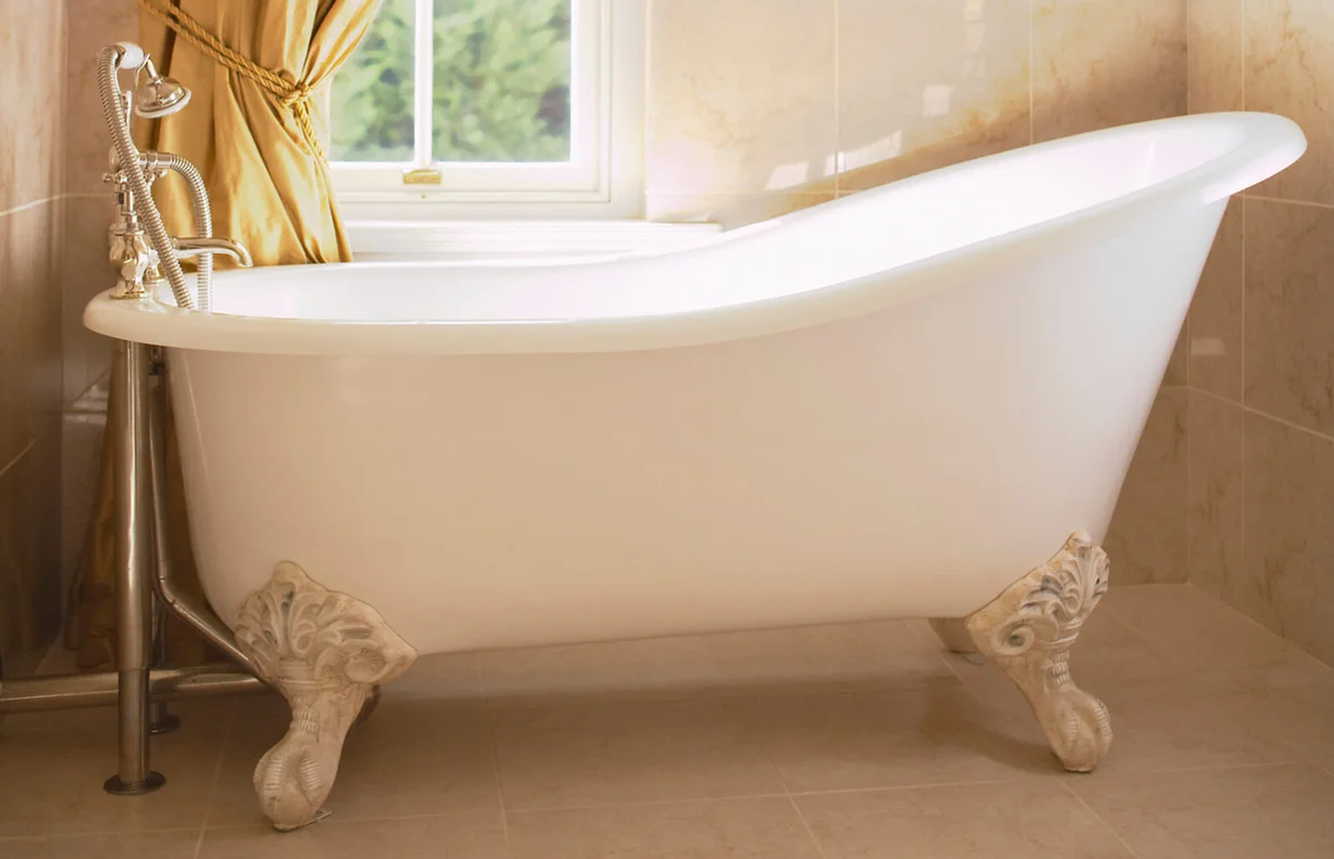 Clawfoot Bathtub Beneath Window Curtain