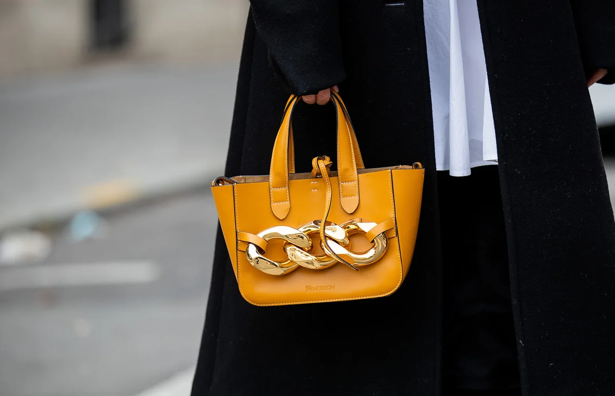 Leonie Hanne is seen wearing white J.W. Anderson blouse dress, J.W. Anderson bag | Getty Editorial Use