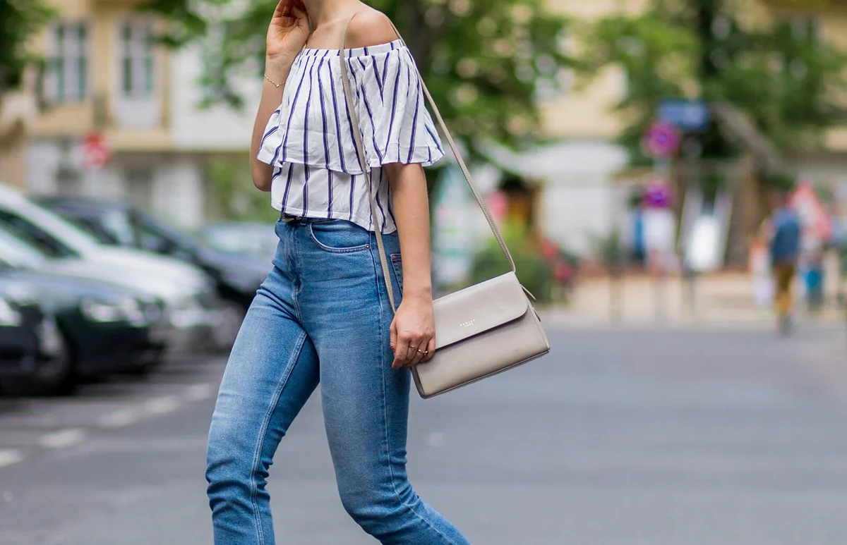 Miriam Mache wearing a white navy striped off shoulder shirt from Zara, a Radley London bag | Getty Editorial Use