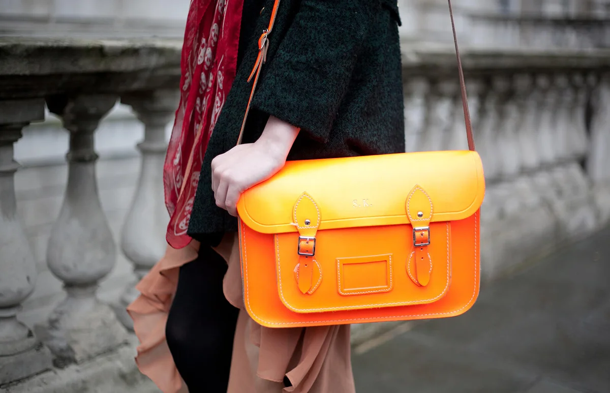 Sofie King wearing Alexander Mcqueen scarf, Topshop coat and skirt, Cambridge satchel compact bag | Getty Editorial Use