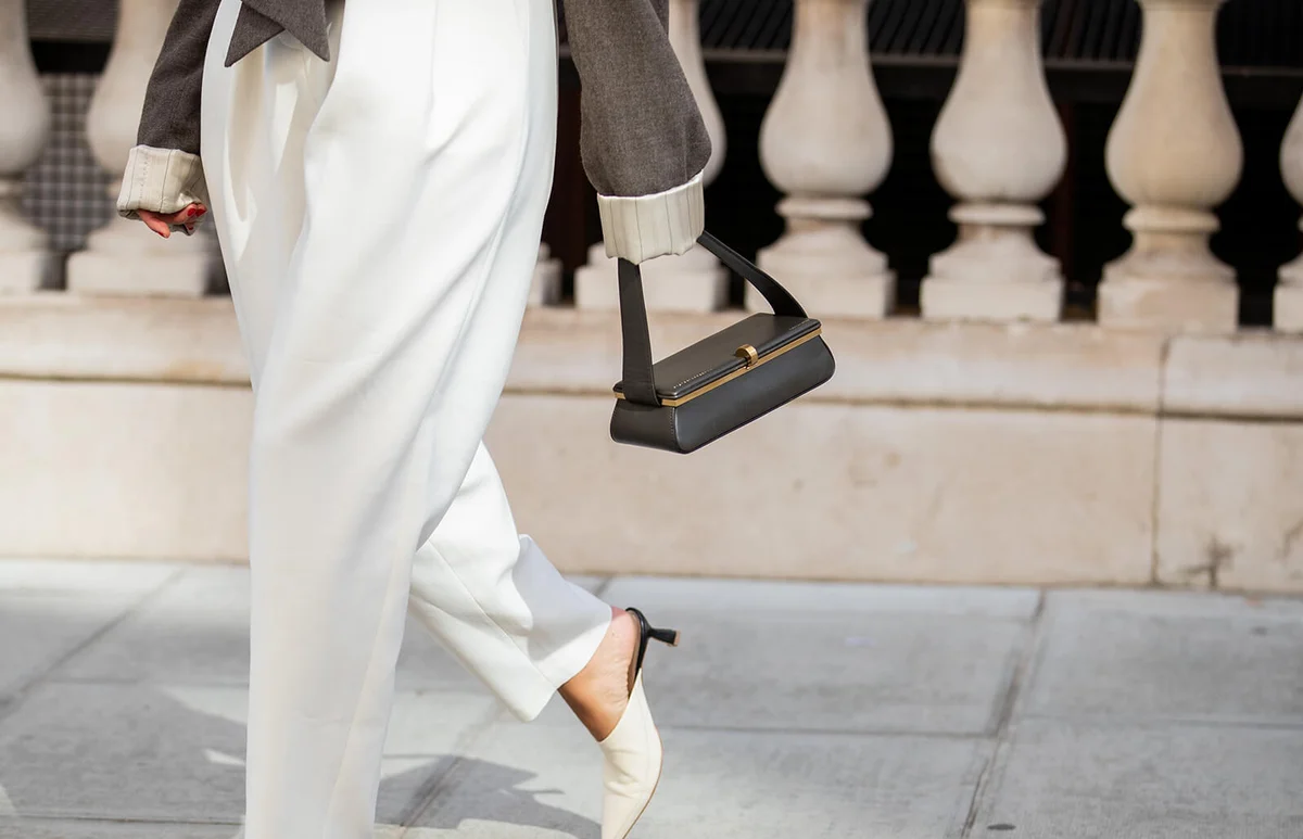 Bettina Looney is seen wearing white pants, white heels, bag outside Victoria Beckham during London Fashion Week | Getty Editorial Use